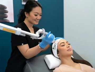 Janet performing an aesthetics treatment on a female patient