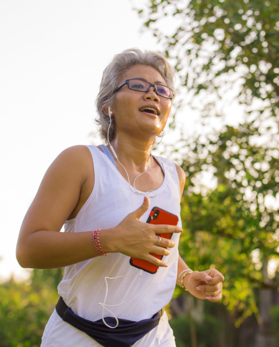 Photo of a woman jogging, listening to music on her phone